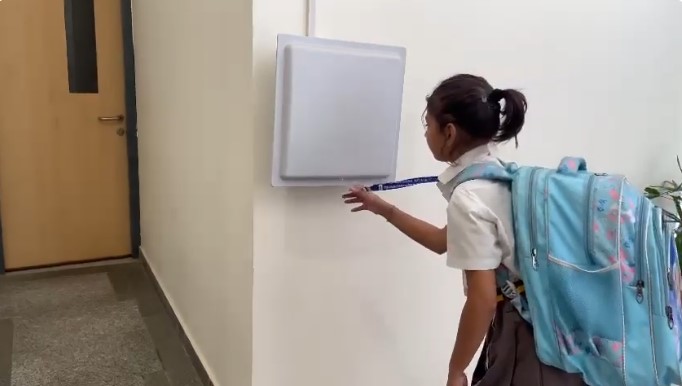 Students using a biometric attendance system for accurate tracking